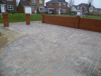 Block paving with brick wall